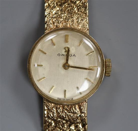 An Omega 9ct gold ladys wristwatch on textured bracelet, boxed